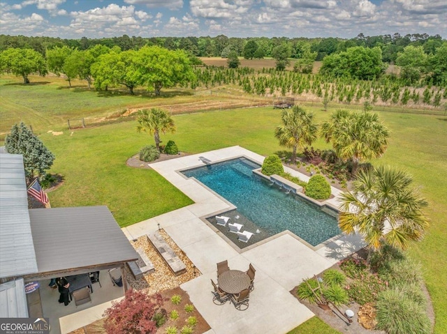 outdoor pool featuring a patio and a lawn