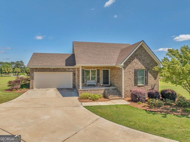ranch-style house featuring a front yard, an attached garage, brick siding, and driveway