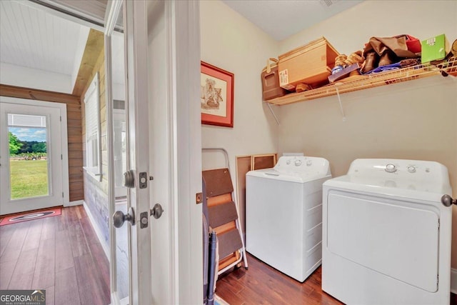 laundry area featuring washing machine and clothes dryer, laundry area, and wood finished floors
