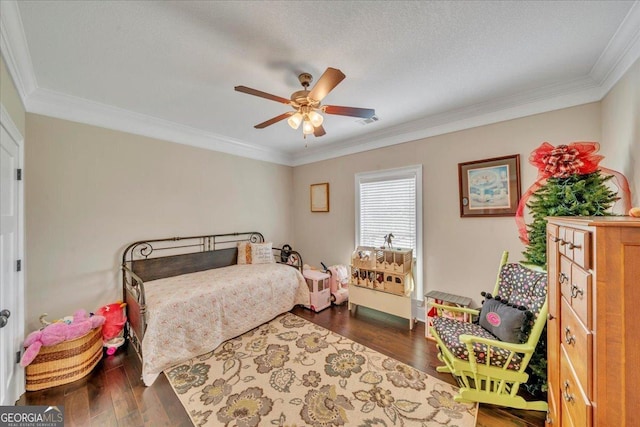 bedroom with ceiling fan, visible vents, crown molding, and wood finished floors