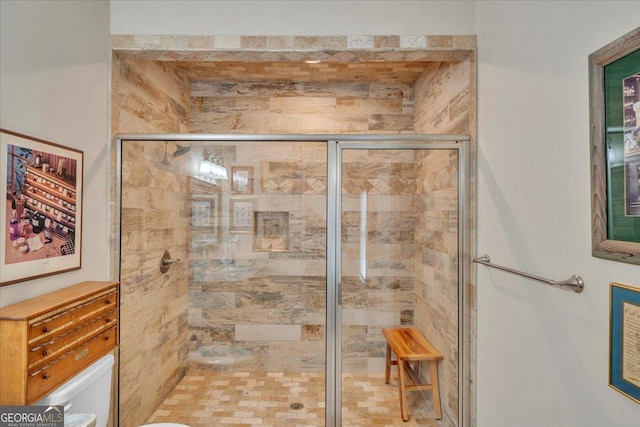bathroom with toilet and a stall shower