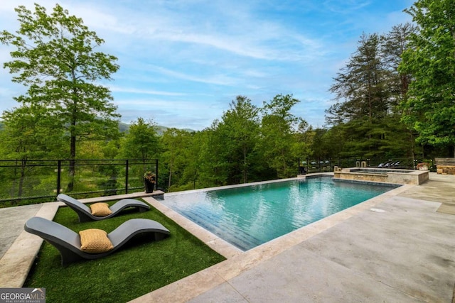 51 Birdseye Vw, Blue Ridge, GA 30513 - view of swimming pool featuring a patio area, a forest view, and a pool with connected hot tub