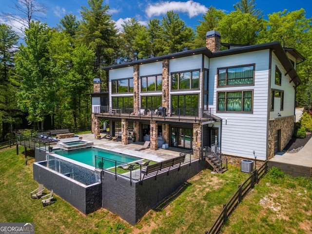 51 Birdseye Vw, Blue Ridge, GA 30513 - rear view of property featuring a chimney, a pool with connected hot tub, a patio area, central air condition unit, and stone siding