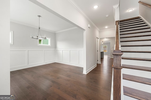 interior space featuring crown molding, dark wood-type flooring, a healthy amount of sunlight, and stairs
