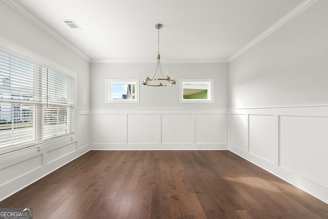 unfurnished dining area with visible vents, a chandelier, crown molding, a decorative wall, and dark wood-style floors