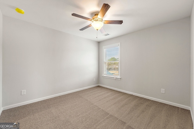 spare room with baseboards, ceiling fan, visible vents, and carpet floors