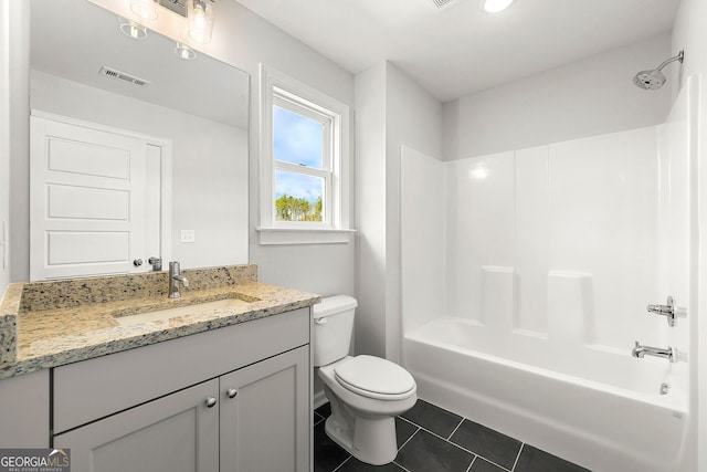 bathroom with toilet, vanity, visible vents, tile patterned flooring, and washtub / shower combination