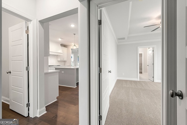 corridor featuring ornamental molding, visible vents, recessed lighting, dark wood-style flooring, and baseboards