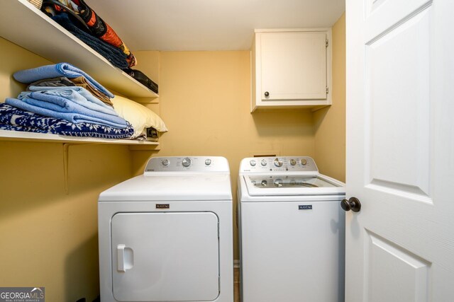 washroom featuring washer and dryer and cabinet space