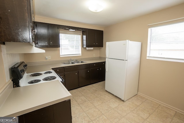 205 Butler St, Waycross, GA 31501 - kitchen featuring a sink, white appliances, light countertops, range hood, and dark brown cabinets