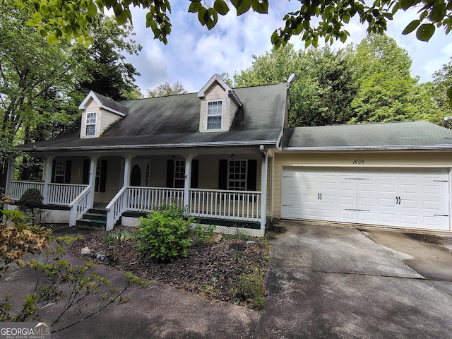 cape cod-style house featuring covered porch, concrete driveway, roof with shingles, and a garage