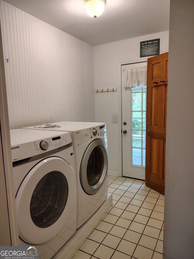 laundry area with light tile patterned floors, laundry area, and washer and clothes dryer