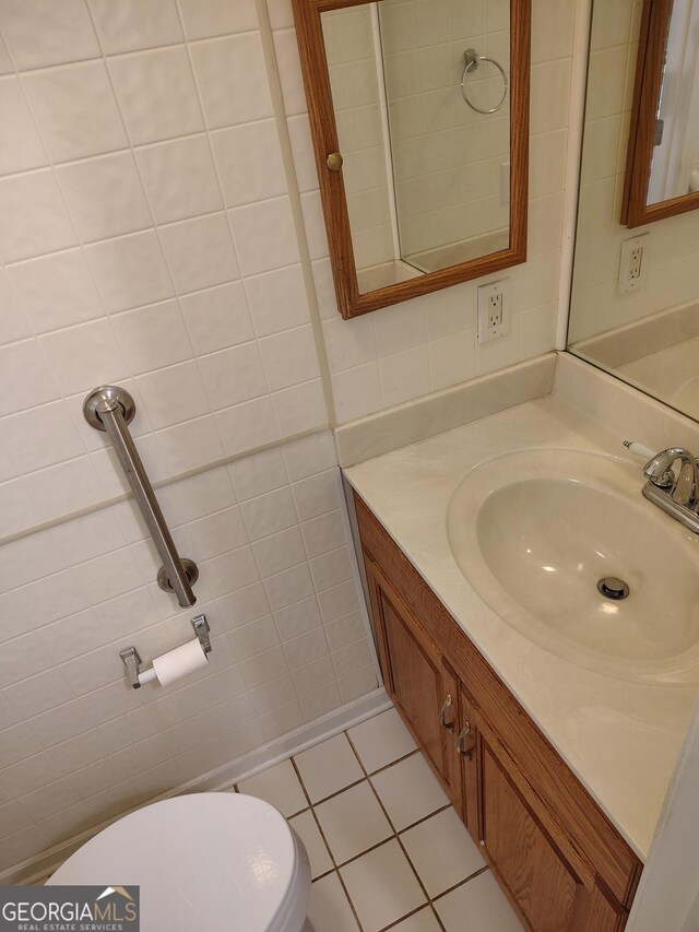 bathroom featuring tile walls, toilet, tile patterned flooring, and vanity