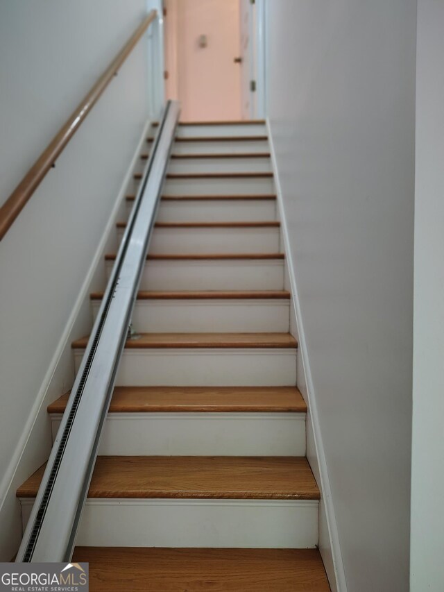staircase with wood finished floors