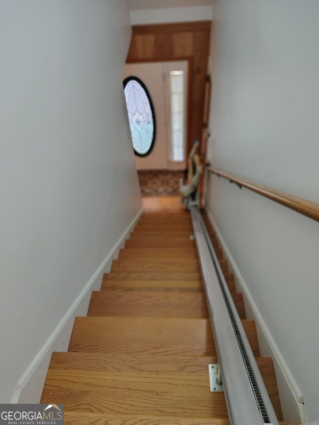 stairway with wood finished floors