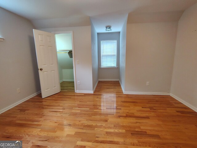 bonus room featuring light wood finished floors and baseboards
