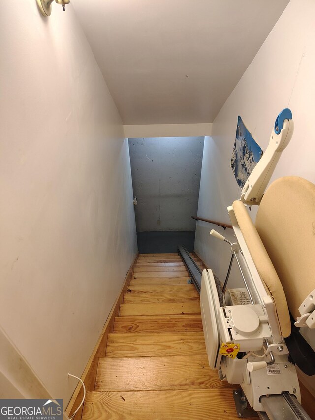 stairway featuring wood finished floors