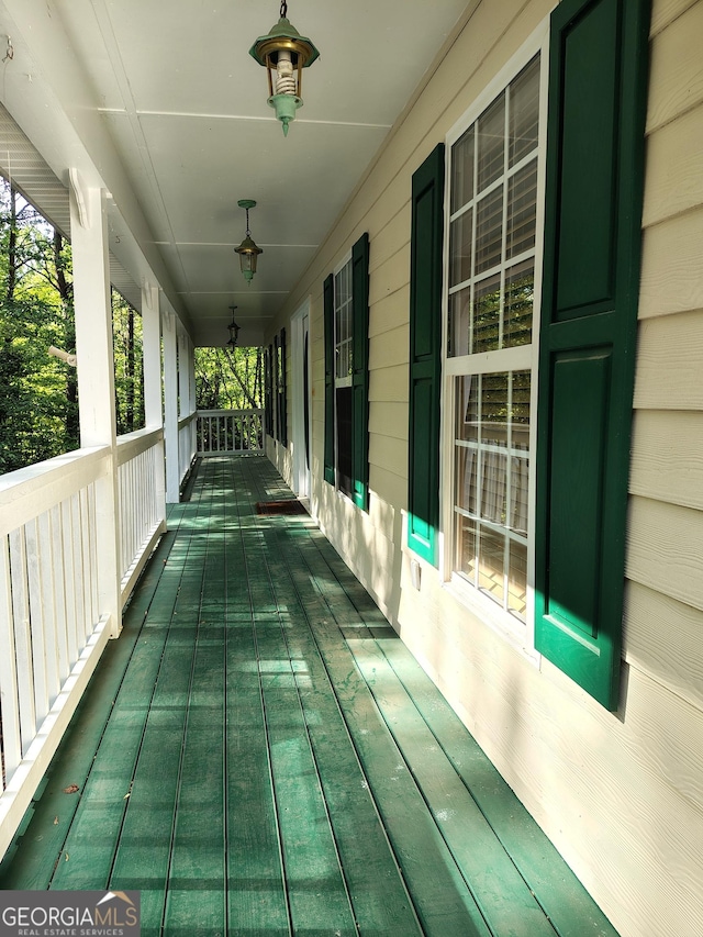 wooden terrace featuring covered porch
