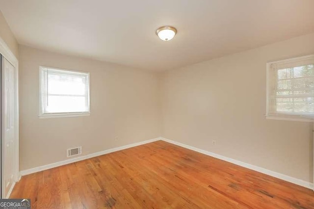 6575 Wendell Cir, Morrow, GA 30260 - spare room with visible vents, wood finished floors, and baseboards