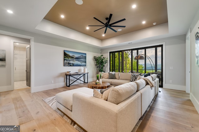 377 Charmont Dr, Tiger, GA 30576 - living room featuring light wood-style flooring, recessed lighting, baseboards, ceiling fan, and a raised ceiling