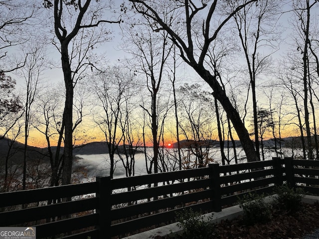 377 Charmont Dr, Tiger, GA 30576 - deck at dusk with a water view and fence