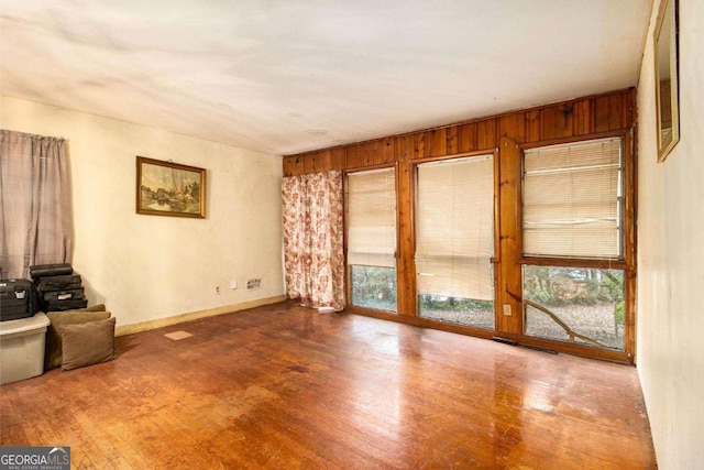 1491 Boulderwoods Dr, Atlanta, GA 30316 - spare room with wood walls, baseboards, and wood finished floors