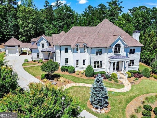13922 Tree Loft Rd, Milton, GA 30004 - view of front of property featuring a chimney, driveway, and a front yard
