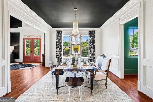 13922 Tree Loft Rd, Milton, GA 30004 - dining room with french doors, a notable chandelier, crown molding, dark wood-style flooring, and a decorative wall