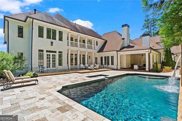13922 Tree Loft Rd, Milton, GA 30004 - back of house featuring a patio area, french doors, an outdoor pool, a balcony, and a chimney