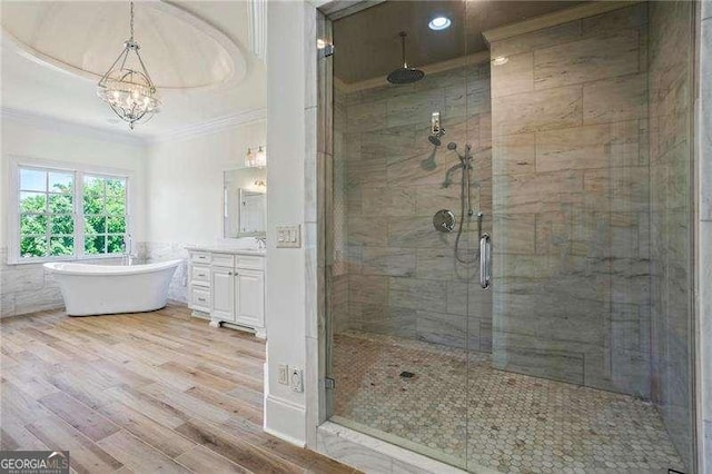 13922 Tree Loft Rd, Milton, GA 30004 - bathroom featuring a notable chandelier, a shower stall, vanity, crown molding, and wood finished floors