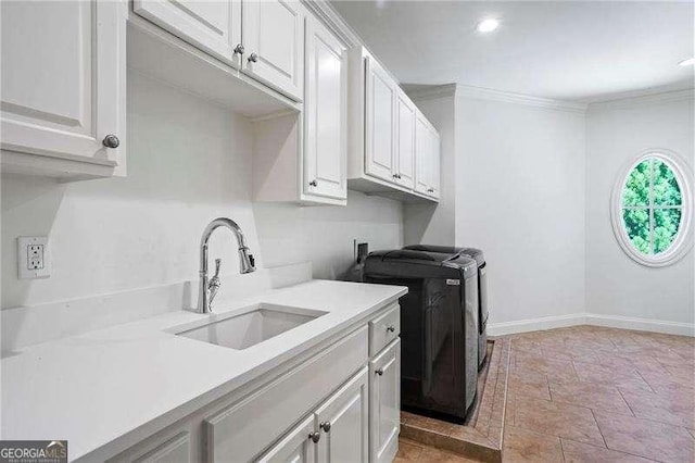 13922 Tree Loft Rd, Milton, GA 30004 - washroom with washing machine and dryer, a sink, cabinet space, baseboards, and ornamental molding