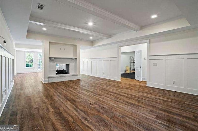 13922 Tree Loft Rd, Milton, GA 30004 - unfurnished living room featuring beam ceiling, crown molding, a multi sided fireplace, a decorative wall, and dark wood-style floors