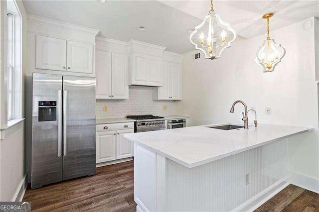 13922 Tree Loft Rd, Milton, GA 30004 - kitchen featuring a peninsula, stainless steel fridge, a sink, a notable chandelier, and dark wood-style flooring