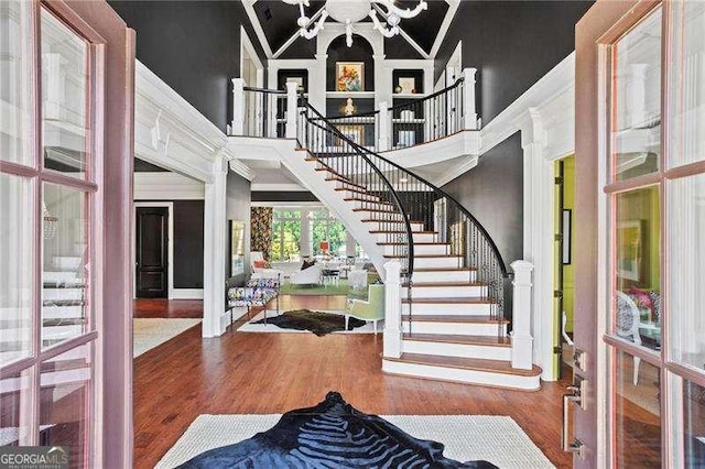 13922 Tree Loft Rd, Milton, GA 30004 - foyer entrance featuring french doors, wood finished floors, a high ceiling, crown molding, and stairway