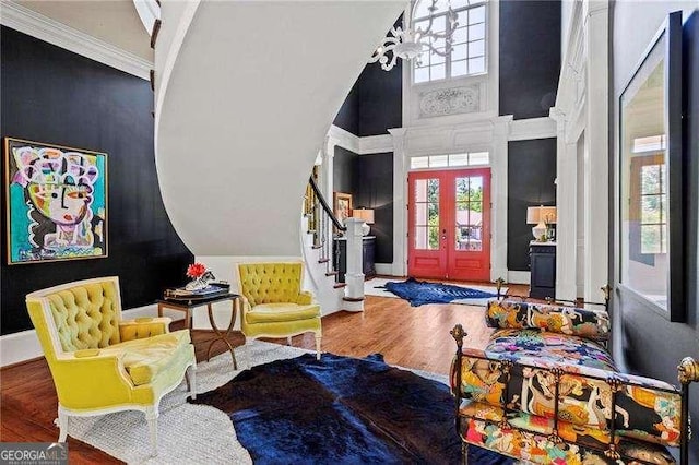 13922 Tree Loft Rd, Milton, GA 30004 - foyer entrance featuring an inviting chandelier, wood finished floors, crown molding, a towering ceiling, and stairs