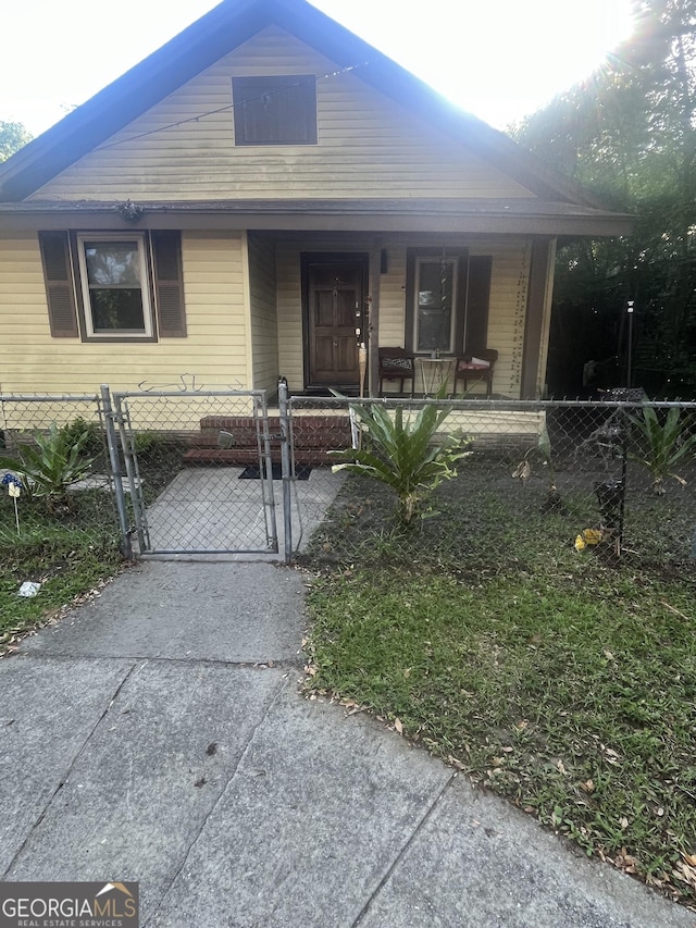 1621 Lee St, Brunswick, GA 31520 - bungalow-style home with a porch, a fenced front yard, and a gate