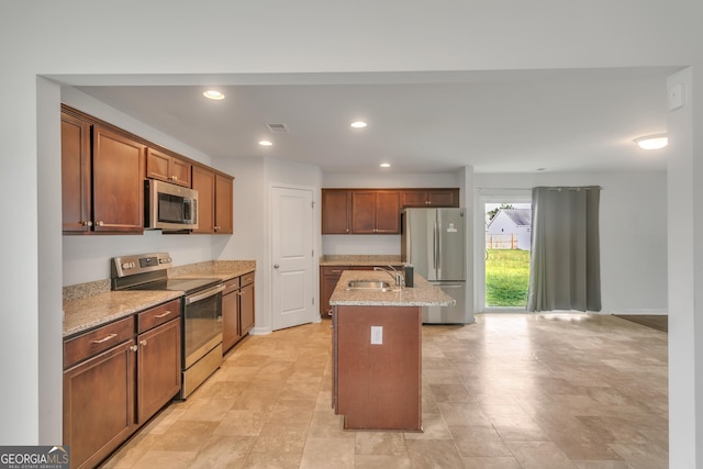 62 Blackberry Cir, Guyton, GA 31312 - kitchen with light stone countertops, recessed lighting, a sink, stainless steel appliances, and an island with sink