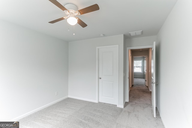 62 Blackberry Cir, Guyton, GA 31312 - unfurnished bedroom featuring light colored carpet, baseboards, ceiling fan, and visible vents