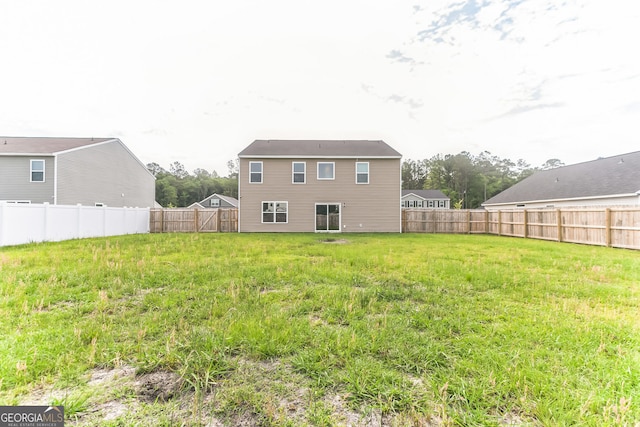 62 Blackberry Cir, Guyton, GA 31312 - rear view of house featuring a yard and a fenced backyard