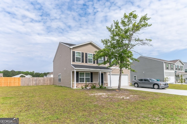 62 Blackberry Cir, Guyton, GA 31312 - traditional-style home featuring concrete driveway, fence, a front yard, and an attached garage
