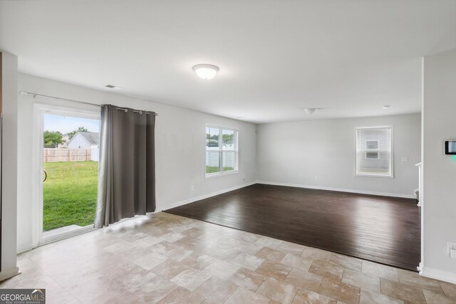 62 Blackberry Cir, Guyton, GA 31312 - unfurnished living room featuring baseboards and stone finish flooring
