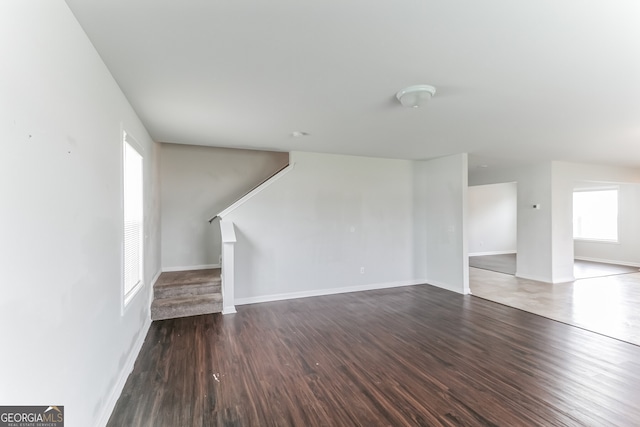 62 Blackberry Cir, Guyton, GA 31312 - unfurnished living room with wood finished floors, baseboards, and stairs