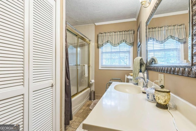 292 Lumpkin St, Winder, GA 30680 - full bath featuring a closet, vanity, a textured ceiling, ornamental molding, and bath / shower combo with glass door