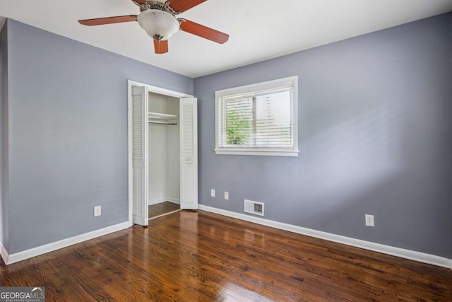 unfurnished bedroom with wood finished floors, visible vents, and baseboards