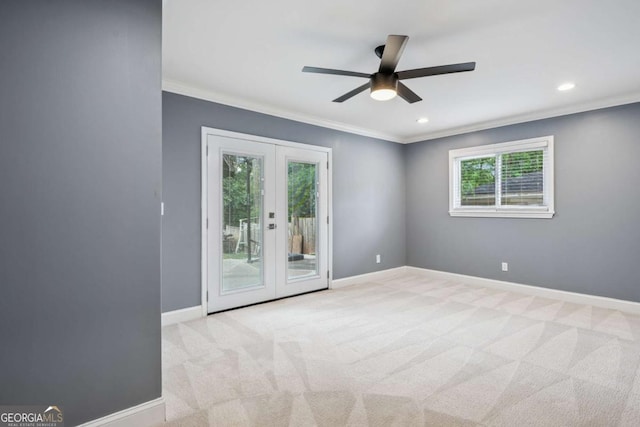 carpeted spare room featuring baseboards, french doors, a ceiling fan, and ornamental molding