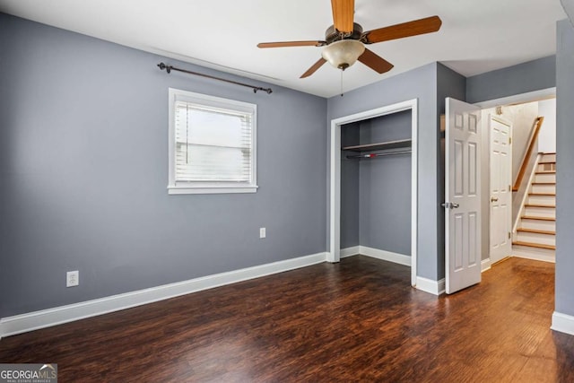 unfurnished bedroom with a closet, dark wood-type flooring, baseboards, and ceiling fan