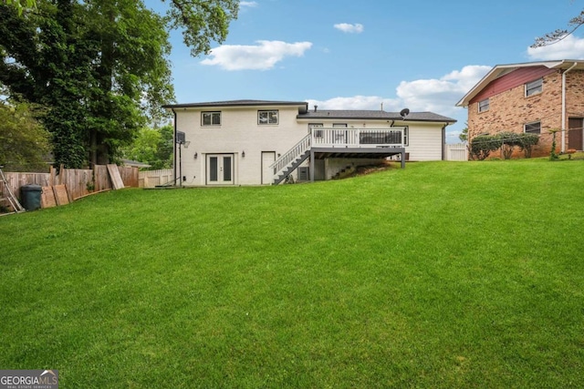 back of house with stairway, a deck, french doors, and a lawn