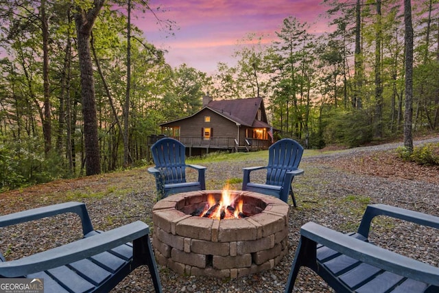 142 Amelia Ln, Blue Ridge, GA 30513 - patio terrace at dusk with an outdoor fire pit and a wooden deck