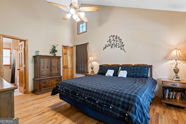 142 Amelia Ln, Blue Ridge, GA 30513 - bedroom featuring ensuite bathroom, light wood-style floors, ceiling fan, and a towering ceiling