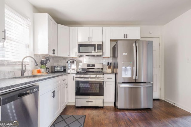 1893 Windsor Dr SW, Atlanta, GA 30311 - kitchen with decorative backsplash, white cabinets, appliances with stainless steel finishes, and a sink